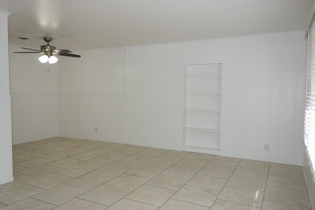 Living room with built in's, dining area on the left with ceiling fan - 5527 E 5th St