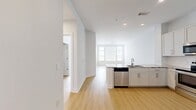 This 760-square-foot, one-bedroom, one-bathroom apartment at 580 S Goddard Blvd in King of Prussia, PA offers a clean, modern aesthetic across a single-floor layout. Light-toned hardwood-style flooring runs throughout the unit, complementing the crisp white walls and creating a bright, cohesive feel.

The open-concept kitchen and living area forms the heart of the apartment. The kitchen is well-equipped with white shaker cabinetry, granite countertops, and a full suite of stainless steel appliances including a range, microwave, refrigerator with ice maker, and dishwasher. A peninsula with a granite top provides additional counter space and connects the kitchen to the living area, which benefits from natural light through large windows with blinds.

The primary bedroom spans 170 square feet, features a ceiling fan, and includes windows overlooking the surrounding community. A dedicated walk-in closet offers built-in shelving and double hanging rods for ample storage. The full bathroom is finished with marble-look tile flooring, a white subway-tiled tub/shower combo, gold-toned fixtures, a white vanity, and granite countertops. A separate laundry area and hallway round out this well-appointed, move-in-ready unit.