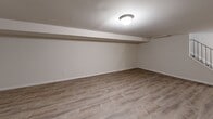 Located at 1480 Parkside Ave in Ewing, NJ, this two-story home offers a well-organized layout spread across two floors, with a basement providing additional utility space. The main level encompasses a living room, dining room, and kitchen, all connected in a practical and open flow. The living room features warm hardwood flooring and clean white walls, creating a bright and welcoming atmosphere. The kitchen is equipped with stainless steel appliances including a gas range and refrigerator, white shaker cabinetry, a single-basin sink, and light wood-look flooring, with a window that brings in natural light. A staircase connects the main level to the upper floor, where the bedroom is located. The spacious bedroom features classic hardwood floors, large windows with blinds, and multiple closets offering generous storage. The full bathroom includes a tub-shower combination with a sliding glass enclosure and a window for natural ventilation. Baseboard heating is present throughout the home. The exterior showcases a traditional brick facade with burgundy shutters, and a private balcony provides outdoor space with views of the surrounding grounds.