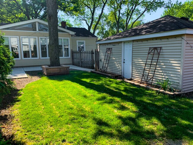 Yard space with patio and grassy area. Lots of room for planting, gardening and entertaining. - 1336 N Eagle St