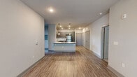 Located at 100 Still Creek Lane in Athens, GA, this well-designed single-story home offers three bedrooms and four bathrooms within a thoughtfully laid-out floor plan. The open-concept living and kitchen area serves as the heart of the home, featuring warm wood-look flooring, recessed lighting, and a ceiling fan that enhances comfort. The kitchen is equipped with gray shaker-style cabinetry, granite-look countertops, a central island with pendant lighting, and a full suite of stainless steel appliances, including a refrigerator, range, microwave, and dishwasher. Natural light flows in through windows at the living area's far end, which is framed by a glass-panel door. Each bedroom is finished with plush carpeting, ceiling fans, and windows that invite natural light and outdoor views. The spacious primary bedroom includes a walk-in closet outfitted with wire shelving for organized storage. The bathrooms are finished with granite-look vanities, gray cabinetry, and tub-shower combinations featuring white tile surrounds with built-in shelving. A neutral color palette of soft grays and whites ties the entire space together, creating a clean, modern, and move-in-ready environment.