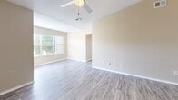 Located at 2603 Silkwood Circle in Orlando, Florida, this single-story, three-bedroom, two-bathroom home offers a well-designed layout with comfortable living spaces throughout. The open-concept living, dining, and kitchen area serves as the heart of the home, featuring wood-look flooring, neutral warm-toned walls, and ceiling fans that enhance the airy feel. Natural light flows in through multiple windows fitted with blinds, brightening the space throughout the day.

The kitchen is a standout feature, boasting white shaker-style cabinetry, granite countertops, a classic subway tile backsplash, and a full suite of stainless steel appliances including a refrigerator, range, and over-the-range microwave. A peninsula with a granite countertop and pendant lighting connects the kitchen to the living and dining area, making it ideal for entertaining. The kitchen also benefits from tall ceilings that enhance its sense of openness.

The three bedrooms are comfortably sized, with the primary bedroom offering ample closet space. Bedrooms feature plush carpeting and windows with outdoor views. The two bathrooms are finished with granite vanity tops, white cabinetry, and wood-look flooring. Additional spaces include a laundry room, utility room, and multiple closets for generous storage throughout.