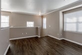 Located at 6704 W 146th Pl in Overland Park, Kansas, this single-floor home offers a thoughtfully designed layout with a cohesive, neutral color palette throughout. The open living and dining areas are unified by rich, dark hardwood-style flooring and warm taupe walls accented by crisp white crown molding and baseboards. Natural light filters through multiple windows fitted with white blinds, creating a bright and welcoming atmosphere. A decorative column adds architectural interest, while a breakfast bar connects the living space to the kitchen, enhancing the open flow.

The kitchen is well-equipped, featuring white cabinetry, granite countertops, a mosaic tile backsplash, stainless steel appliances including a refrigerator, range, microwave, and dishwasher, and a deep undermount sink. Hardwood-style flooring continues through this space, maintaining visual consistency.

The bedrooms are finished with plush carpeting and receive ample natural light. The primary bedroom includes a ceiling fan, a walk-in closet, and direct access to a private bathroom. The bathroom features granite countertops, white cabinetry, a tiled tub-shower combination, and hardwood-style flooring, offering a clean and functional finish throughout.