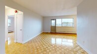 Located at 345 Lakeshore Rd W in Mississauga, this 2-bedroom, 1-bathroom unit offers a well-organized layout across a single floor. Gleaming parquet flooring flows throughout the living areas and bedrooms, lending a warm, classic character to the space. The living area is generously proportioned, featuring large windows that frame scenic views of the city skyline and surrounding greenery, allowing ample natural light to fill the room. A balcony door provides direct outdoor access, extending the living space further.

The kitchen is thoughtfully designed with modern light wood cabinetry, white countertops, a subway tile backsplash, and stainless steel appliances including a refrigerator and range. Tiled flooring in the kitchen adds a clean, practical contrast to the parquet elsewhere. A dedicated dining area sits conveniently nearby.

The primary bedroom is spacious and bright, with a large window offering pleasant outdoor views and baseboard heating. The second bedroom is well-sized and features dual closets for excellent storage. Both rooms carry the same warm parquet flooring.

The bathroom is finished with elegant marble-style wall tiles surrounding a full soaking tub. Additional storage is provided throughout via multiple closets accessible from the hallway and entrance.