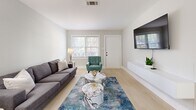 Located at 204 Chambers Cove Drive in Macon, Georgia, this single-story, 2-bedroom, 1-bathroom home offers a thoughtfully designed layout with modern finishes throughout. Light wood-tone flooring flows seamlessly across the entire space, creating a cohesive and airy feel.

The living room serves as the welcoming centerpiece of the home, featuring multiple windows with white blinds that invite natural light and provide views of the surrounding greenery. The open, functional layout accommodates comfortable seating alongside a dedicated media wall.

The kitchen is outfitted with gray cabinetry, marble-look countertops, and stainless steel appliances, including a full-size refrigerator. A window above the sink adds natural light to the workspace, while ample upper and lower cabinet storage enhances practicality.

The primary bedroom is a well-sized retreat with a double window, a closet, and clean neutral walls. The second bedroom also features a double-door closet, a window, and generous floor space. Both rooms share a refined full bathroom appointed with marble-look tile surrounds in the shower and coordinating flooring.

Neutral gray walls throughout the home provide a versatile backdrop, while white trim and doors lend a crisp, polished contrast. The overall ambiance is clean, modern, and move-in ready.