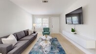 Located at 204 Chambers Cove Drive in Macon, Georgia, this single-story, 2-bedroom, 1-bathroom home offers a thoughtfully designed layout with modern finishes throughout. Light wood-tone flooring flows seamlessly across the entire space, creating a cohesive and airy feel.

The living room serves as the welcoming centerpiece of the home, featuring multiple windows with white blinds that invite natural light and provide views of the surrounding greenery. The open, functional layout accommodates comfortable seating alongside a dedicated media wall.

The kitchen is outfitted with gray cabinetry, marble-look countertops, and stainless steel appliances, including a full-size refrigerator. A window above the sink adds natural light to the workspace, while ample upper and lower cabinet storage enhances practicality.

The primary bedroom is a well-sized retreat with a double window, a closet, and clean neutral walls. The second bedroom also features a double-door closet, a window, and generous floor space. Both rooms share a refined full bathroom appointed with marble-look tile surrounds in the shower and coordinating flooring.

Neutral gray walls throughout the home provide a versatile backdrop, while white trim and doors lend a crisp, polished contrast. The overall ambiance is clean, modern, and move-in ready.