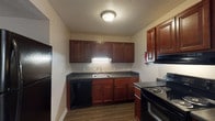 Located at 200 Verdant Dr in Greenville, NC, this single-floor residence offers a practical and comfortable layout designed for everyday living. Throughout the unit, wood-look vinyl flooring provides a cohesive and easy-to-maintain foundation, complemented by neutral-toned walls and textured ceilings that lend a warm, understated aesthetic.

The kitchen is a functional highlight, featuring rich dark-wood cabinetry with ample upper and lower storage, dark countertops, and a full suite of black appliances including a refrigerator, electric range, and dishwasher. Under-cabinet lighting illuminates the workspace, and the layout maximizes efficiency in a compact footprint.

The living area is open and well-lit, with a large window allowing natural light to fill the space. A ceiling fan adds both comfort and character to the room. A conveniently located storage closet with a hanging rod adds practical utility just off the main living area.

The bedrooms are generously proportioned, each featuring windows with blinds and ample floor space. One bedroom includes a walk-in closet, offering notable storage capacity. The bathroom is clean and functional, equipped with a full tub and shower combination featuring built-in shelving and chrome fixtures. This unit delivers straightforward, move-in-ready living in a well-maintained setting.