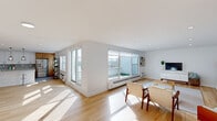 This thoughtfully designed 2-bedroom, 2-bathroom residence in Red Bank, NJ offers a bright and modern living experience across a generous single-floor layout. Light hardwood flooring flows throughout the open-concept living and dining areas, which are bathed in natural light from large sliding glass doors that open to an outdoor balcony, offering views of the surrounding neighborhood.

The renovated kitchen is a standout feature, showcasing a striking combination of warm wood cabinetry, crisp white upper cabinets, and expansive quartz countertops. A large central island with pendant lighting and bar seating anchors the space, while stainless steel appliances and a subway tile backsplash complete the contemporary design. The kitchen connects seamlessly to the living area, making it ideal for entertaining.

The spacious primary bedroom features parquet hardwood flooring, ample natural light, and generous built-in closet space with dedicated storage areas. The second bedroom also features parquet flooring and a large closet. Both bathrooms are elegantly finished, with marble-look tile flooring, wood-toned vanities, and frameless glass shower enclosures complemented by large-format tile surrounds.

The open entryway sets a welcoming tone with clean white walls and warm wood accents, reflecting the cohesive modern aesthetic carried throughout this well-appointed Red Bank residence.