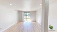 Located at 44197 Hayes Rd in Sterling Heights, Michigan, this well-appointed one-bedroom, one-bathroom home offers a thoughtfully designed single-floor layout with a clean, modern aesthetic. Light-toned hardwood-style flooring flows throughout the main living areas, complementing the neutral gray walls and recessed lighting that keep the space feeling bright and airy.

The open-plan living, dining, and kitchen area serves as the heart of the home. The living room receives generous natural light through a large sliding glass door that opens directly to a private patio, offering outdoor views and easy exterior access. The kitchen is well-equipped with warm oak cabinetry lining both walls, white countertops, a stainless steel sink, an electric range, a dishwasher, a refrigerator, and a ceiling fan overhead. Tile flooring in the kitchen provides a practical transition from the main living space.

The spacious primary bedroom features light flooring, a window with outdoor views, and notably generous closet storage — with two large sliding wood-panel closets offering exceptional organization capacity. A hallway connects the bedroom to the full bathroom, which includes a tiled tub-shower combination with a grab bar. Six closets throughout the home ensure abundant storage options for everyday living.