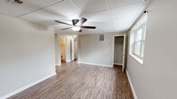Located at 3300 Valley View Dr in Knoxville, Tennessee, this three-bedroom, one-bathroom home offers a straightforward single-floor layout designed for comfortable everyday living. Wood-look plank flooring runs consistently throughout the home, providing a cohesive and easy-to-maintain finish. Drop tile ceilings with ceiling fans are found in every room, contributing to a consistent aesthetic and practical air circulation.

The spacious primary bedroom features a built-in closet and connects conveniently to the rest of the home. The two additional bedrooms are well-proportioned, each with a ceiling fan, a window for natural light and outdoor views, and closet access — one equipped with a reach-in closet with bifold doors. A dedicated closet space also houses the water heater utility.

The kitchen is well-appointed with white cabinetry, stone-look countertops, stainless steel appliances including a range and refrigerator, a double basin sink, and a skylight panel that brings in overhead natural light. The bathroom includes a tiled tub-surround shower, toilet, and vanity with a window for ventilation and light.

The open living area benefits from natural light through a front-facing window and a ceiling fan, creating an airy and functional common space throughout this compact Knoxville home.