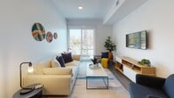 Located at 205–233 E Seaside Way in Long Beach, California, this contemporary single-floor residence offers a thoughtfully designed layout with modern finishes throughout. The kitchen is a standout feature, showcasing dark flat-front cabinetry, a striking black subway tile backsplash, white quartz countertops, stainless steel appliances including a gas range, built-in microwave, dishwasher, and refrigerator, complemented by warm wood open shelving for display and storage. Hardwood-style flooring runs throughout the unit, tying the spaces together seamlessly. The open living area is bright and airy, benefiting from abundant natural light streaming through sliding glass doors that lead to a private balcony with views of the surrounding neighborhood and mature palm trees. The bedroom continues the serene, light-filled atmosphere, featuring direct balcony access framing picturesque palm tree views, along with a spacious closet. The bathroom is clean and modern, with large-format tile surrounding the soaking tub and shower combination, wood-look flooring, and recessed lighting. Overall, the space exudes a calm, contemporary coastal ambiance well-suited to the vibrant Long Beach waterfront neighborhood.