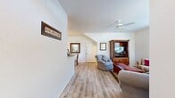 Located at 2500 Merchants Row Blvd in Tallahassee, FL, this single-story, one-bedroom, one-bathroom home offers a well-organized layout across a comfortable living footprint. Light wood laminate flooring runs throughout, creating a cohesive and clean aesthetic in every room.

The welcoming entrance opens into a spacious living room featuring a ceiling fan, large windows that invite natural light, and views of lush Florida greenery outside. The living area flows naturally into the dedicated dining room, which is accented by an elegant chandelier and connects seamlessly to the galley-style kitchen. The kitchen is equipped with ample warm-toned wood cabinetry, granite-style countertops, black appliances including a refrigerator, electric range, microwave, and dishwasher, along with a window that brightens the cooking space.

The bedroom is a tranquil retreat with soft neutral walls, light wood flooring, and a window that fills the room with natural light. A dedicated closet and a utility room add practical storage and functional space to the home. The full bathroom features tile flooring, a granite-style vanity, and a tub-shower combination. A dedicated entrance area completes the thoughtful layout, making this home efficient, comfortable, and move-in ready.