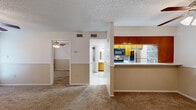 Located at 4501 Summerhill Rd in Texarkana, TX, this well-organized one-bedroom, one-bathroom unit makes efficient use of its single-floor layout. The open-concept living and dining area serves as the heart of the home, featuring warm neutral tones, plush carpeting, a textured ceiling, and a ceiling fan with light fixture. A standout feature is the tile-surround fireplace, which anchors the living room and adds a cozy focal point, complemented by a sliding glass door that lets in natural light.

The galley-style kitchen is accessible via a half-wall breakfast bar and is finished with warm wood cabinetry, light countertops, tile flooring, and a decorative stone mosaic backsplash. It is equipped with a full suite of appliances, including a refrigerator, electric range, microwave, and dishwasher.

The bedroom is a comfortable, carpeted retreat with a ceiling fan, natural light from a window with blinds, and two-tone painted walls consistent with the rest of the unit. It connects directly to a walk-in closet with full-length hanging rods and tile flooring, offering generous storage.

The bathroom features a wood vanity with a light stone countertop, a framed mirror, and a separate tub/shower combo with tile surround, all finished with neutral tile flooring throughout.