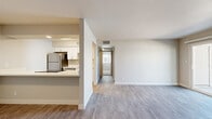 Located in Peoria, Arizona, this 2-bedroom, 1-bathroom single-story home offers a clean, modern aesthetic throughout. The open-concept living and dining area is finished with light-toned luxury vinyl plank flooring and neutral walls, creating a bright and welcoming atmosphere. A sliding glass door with vertical blinds connects the living space to an outdoor patio, allowing natural light to fill the room.

The galley-style kitchen is well-appointed with white shaker cabinetry, light quartz countertops, and a full suite of stainless steel appliances, including a refrigerator, range, and dishwasher. A hallway connects the main living area to the private quarters of the home.

Both bedrooms feature plush carpeting and dedicated closets, providing comfortable and functional retreats. The primary bedroom is a generous size, offering ample space for furnishings. The full bathroom includes a white vanity with quartz countertop, brushed gold fixtures, and a tub-shower combination with built-in shelving. A hallway connects all rooms efficiently, with two closets providing additional storage. The home presents a cohesive, updated interior with a neutral palette throughout.
