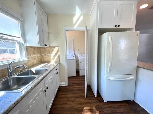 Kitchen with view to laundry room - 701 Atchison St
