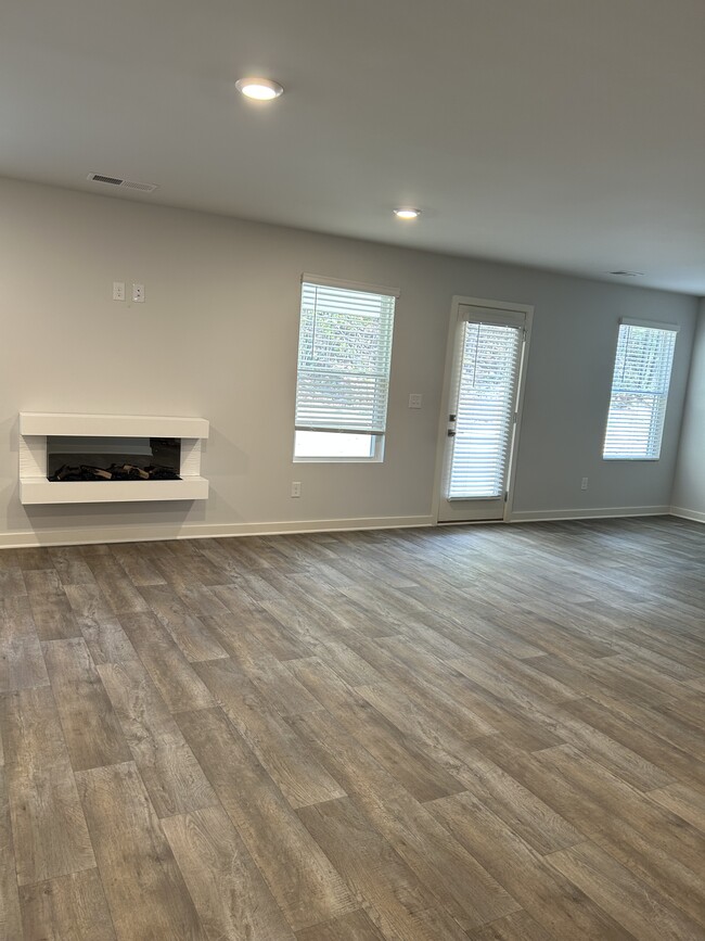 End of hallway entering the living room. To the right is the dining area & kitchen - 226 River Meadow Dr