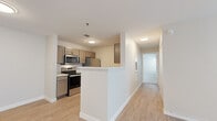 Located at 117 Sterling Ct in Savoy, IL, this single-floor, two-bedroom, two-bathroom residence offers a practical and well-designed layout. Light wood-style flooring flows throughout the main living areas, giving the space a clean, cohesive look. The kitchen is equipped with stainless steel appliances — including a range, microwave, refrigerator, and dishwasher — complemented by warm taupe cabinetry, white countertops, and a peninsula that provides a natural division between the kitchen and living area. The living room is bright and open, with dual windows that invite natural light and outdoor views. Both bedrooms feature plush carpeting for added comfort. The primary bedroom includes a sliding double-door closet, while both bedrooms benefit from natural light provided by well-positioned windows. The two bathrooms are finished consistently, each featuring light wood-tone vanity cabinetry, white countertops, large mirrors, and brushed metal fixtures. One bathroom also includes grab bars, adding a practical accessibility feature. Neutral wall tones throughout the home create a versatile backdrop, making the space easy to personalize. The overall ambiance is clean, modern, and move-in ready.