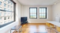 This 1080 square foot apartment in the heart of Chicago offers a blend of comfort and urban sophistication. Located at 80 E Van Buren St, the space boasts 4 bedrooms, including a 110 square foot primary bedroom, 2 bathrooms, an office, and a living room, all spread across a single floor.

The apartment features hardwood flooring throughout, creating a warm and inviting atmosphere. Large windows in the living areas and bedrooms flood the space with natural light and provide breathtaking views of Lake Michigan and the surrounding cityscape. The living room is spacious, with ample seating and a modern entertainment setup.

Bedrooms are comfortably sized, with the primary bedroom offering a generous 110 square feet of space. The bathrooms are well-appointed, featuring modern fixtures, including a combination of shower/tub units and a separate standing shower.

The apartment's layout includes three hallways, ensuring easy navigation between rooms. An office space adds functionality for those working from home. The overall design emphasizes clean lines and a neutral color palette, allowing residents to personalize the space to their taste.

With its prime downtown location and stunning views, this apartment offers the quintessential Chicago living experience, blending urban convenience with comfortable, well-designed living spaces.