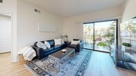 Located in Los Angeles, this 2-bedroom, 2-bathroom residence offers a thoughtfully designed single-floor layout that maximizes both comfort and functionality. The open-concept living and kitchen area serves as the heart of the home, featuring light hardwood flooring that flows seamlessly throughout. The kitchen is well-equipped with warm wood cabinetry, dark granite countertops, stainless steel appliances including a gas range and refrigerator, recessed lighting, and a peninsula with bar seating — ideal for casual dining or entertaining. The living area is bright and airy, benefiting from natural light and sliding glass doors that open to a private balcony with views of palm trees and the surrounding neighborhood. Both bedrooms offer windows with natural light and dedicated closet space. The primary bathroom features a wide vanity with dark countertops, wood cabinetry, and a full tub-shower combo with glass sliding doors. The second bathroom is clean and functional, also offering a tub-shower combination. Additional highlights include an in-unit laundry area, a dedicated dining space, and a layout that balances open living with private retreats. This residence delivers practical, comfortable urban living in the heart of Los Angeles.