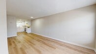 Located at 5870 58th St N in Kenneth City, FL, this well-appointed 2-bedroom, 2-bathroom single-story home offers a clean, modern aesthetic throughout. Light-toned hardwood flooring flows seamlessly across the entire living space, complemented by neutral walls and textured ceilings that create a bright, airy atmosphere.

The open-concept main area combines the living room, dining space, and kitchen into one cohesive layout. The kitchen is a standout feature, showcasing white shaker-style cabinetry with brushed nickel hardware, light quartz countertops, a stainless steel refrigerator, electric range, and dishwasher, all centered around a window that invites natural light.

Both bedrooms are comfortably sized with natural light from large windows dressed with blinds, and each includes a closet with bi-fold doors. The primary bedroom offers a generous footprint with ample wall space. The bathrooms are thoughtfully updated, featuring white shaker vanities with quartz countertops, round mirrors, brushed nickel fixtures, and one bathroom with a fully tiled walk-in shower. Additional highlights include four closets for generous storage and a dedicated laundry area.