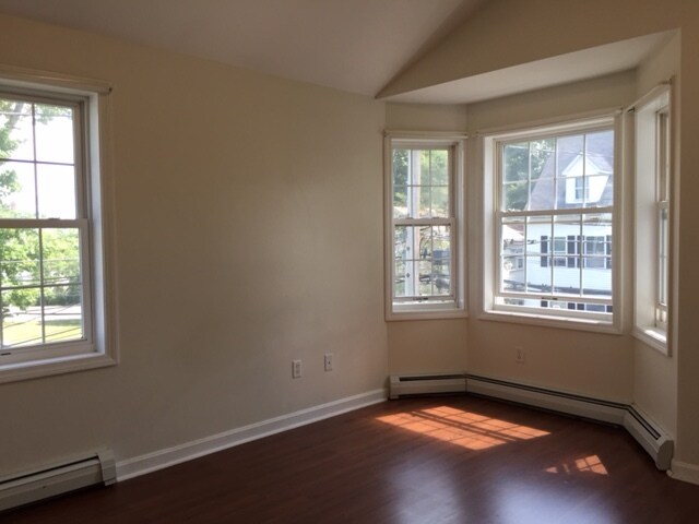 Upstairs, master bedroom with vaulted ceilings and a lighted ceiling fan and peek-a-boo view of the water. - 40 Government St