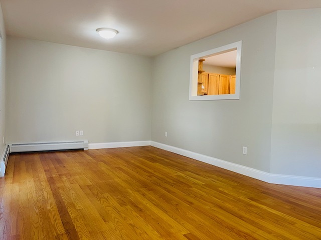 Living room adjacent to kitchen with peek through to stay connected - 32 Westville Ave