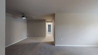 This 930 square foot apartment at Seneca Place offers a thoughtful single-floor layout with three bedrooms and three full bathrooms. The modern kitchen is a highlight, featuring dark wood cabinetry, granite countertops, and stainless steel appliances. Large windows throughout provide ample natural light, creating a bright and airy atmosphere.

The primary bedroom is particularly spacious at 370 square feet, offering plenty of room for relaxation and storage. All bedrooms feature plush carpeting for comfort underfoot. The bathrooms are well-appointed with contemporary fixtures and wood-look flooring that extends into the hallways and laundry area.

The apartment includes an in-unit laundry room, adding convenience to daily life. A mix of carpeting in bedrooms and wood-look flooring in common areas creates a cohesive design throughout. The neutral color palette allows for easy personalization.

With its efficient use of space, modern amenities, and attention to detail, this apartment offers a comfortable and stylish living environment. The layout is ideal for those seeking a balance of private and shared spaces in a contemporary setting.