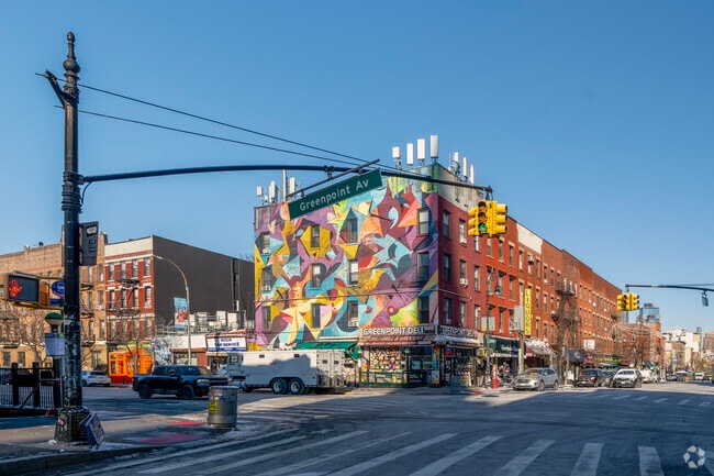 A colorful and vibrant mural adorns the wall of Greenpoint Deli in Greenpoint.