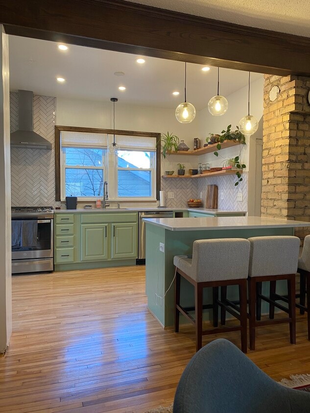 Open kitchen with island. All new appliances. - 3224 38th Ave S