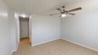 Located at 2307 Botanical Dr in Killeen, TX, this single-story, 2-bedroom, 1-bathroom home offers a practical and functional layout with consistent light tile flooring throughout. The interior is finished with neutral gray walls and textured ceilings, creating a clean, move-in-ready atmosphere.

The kitchen is a standout feature, equipped with gray shaker-style cabinetry, dark granite countertops with a matching backsplash, black stainless steel appliances including a refrigerator and dishwasher, and a ceiling-mounted light fixture. Both bedrooms are well-proportioned, each featuring ceiling fans with light kits and vaulted ceiling details that add a sense of height and openness. The primary bedroom includes a dedicated closet with a clothing rod. In total, the home offers three closets, providing generous storage options throughout.

The full bathroom is neatly appointed with a gray vanity, dark granite countertop, a framed mirror, and a tub-shower combination. A central hallway connects the main living areas and bedrooms, contributing to an efficient floor plan. The overall design is understated and functional, making this home a solid and practical option in Killeen, TX.