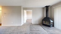 Located at 2809 S Emporia St in Wichita, Kansas, this single-floor, 2-bedroom, 2-bathroom home offers a practical and comfortable layout. The living room is a welcoming space featuring plush carpeting, neutral wall tones, a textured ceiling, and a striking black wood-burning stove that serves as a focal point. A sliding glass door fills the room with natural light and provides direct access to an outdoor area with views of surrounding greenery.

The kitchen is well-appointed with warm oak cabinetry, light granite-style countertops, wood-look vinyl flooring, and white appliances including a coil-top range and dishwasher. A window allows natural light into the space, and the layout flows conveniently toward the living area via a connected hallway.

The primary bedroom includes carpeted flooring, a dedicated closet, and a private en-suite bathroom, while the second bedroom also features carpet and a window with outdoor views and a built-in closet with louvered bifold doors. Both bathrooms are outfitted with full soaking tub and shower combinations, oak overhead cabinetry, and clean white fixtures. Textured ceilings are consistent throughout the home, contributing to a cohesive, understated aesthetic.