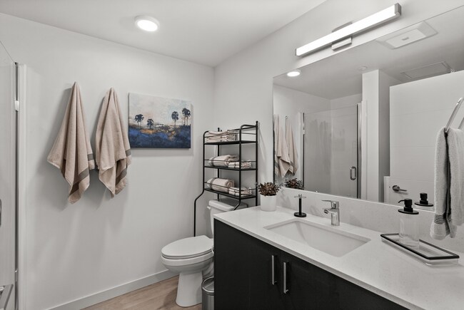 Bright, modern bathroom with sleek finishes and a walk-in shower. - The Ruby