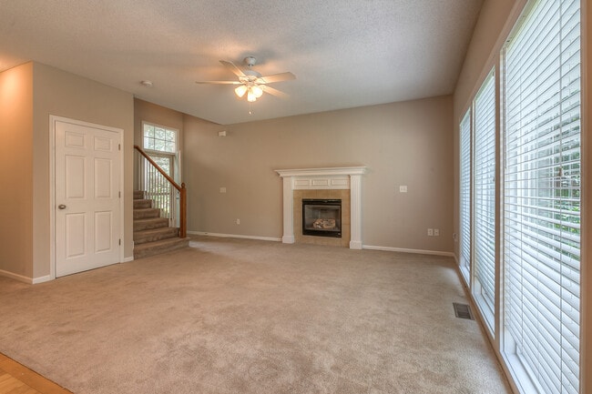 living room with large widows and firepace - 22810 West 71st Terrace