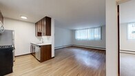 This 550 square foot apartment in Minneapolis offers a thoughtful blend of functionality and style. The single-floor layout encompasses one bedroom, one bathroom, a kitchen, living room, and a hallway, creating an efficient living space. The primary bedroom, measuring 150 square feet, provides a cozy retreat.

The apartment features a mix of flooring types, with warm wood-look floors in the main living areas and kitchen, and plush carpeting in the bedroom for added comfort. Large windows throughout allow natural light to flood the space, creating an airy ambiance and offering views of the surrounding area.

The kitchen, while compact, is well-equipped with dark wood cabinetry, providing ample storage. Stainless steel appliances, including a refrigerator, stove, and built-in microwave, offer modern convenience. The bathroom showcases clean lines with white tile work, a combination bathtub and shower, and essential fixtures.

The living area's open-concept design allows for flexible furniture arrangement, making the most of the available space. Crisp white walls throughout provide a neutral backdrop, ready for personalization. Baseboard heating ensures comfort year-round in Minneapolis's varying climate.

Located at 3701 W Lake St, this apartment combines urban living with a practical, no-fuss approach to design, ideal for those seeking a streamlined lifestyle in the heart of Minneapolis.