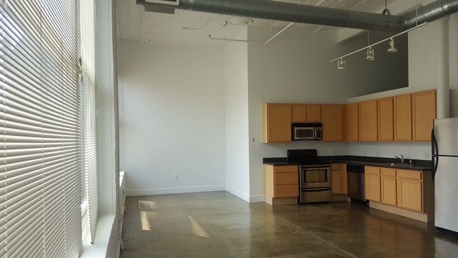 J Lofts Managed By Buckingham Urban L Apartments Downtown Indianapolis Historic Apartments Open Kitchen And Living Area At J Lofts Managed By Buckingham Urban