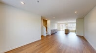 Located at 1619 N Neva Ave in Chicago, IL, this modern three-story home offers four bedrooms and four full bathrooms across a thoughtfully designed layout. The ground floor features an attached two-car garage with an automated opener and clean concrete flooring, providing convenient interior access.

The main living level showcases an open-concept kitchen and living area bathed in natural light from large windows. The kitchen is outfitted with light wood cabinetry, stainless steel appliances including a French door refrigerator and built-in microwave, a gas range, and a spacious white quartz island with pendant lighting—ideal for both cooking and entertaining. Warm hardwood flooring flows throughout this level, complementing the bright, neutral palette.

Upper floors house the bedrooms, each carpeted and featuring windows with outdoor views of the surrounding neighborhood. The primary bedroom includes a dedicated walk-in closet with wire shelving. The bathrooms are finished in a clean, contemporary style with light wood vanities, white quartz countertops, tiled tub-shower combinations, and light stone-look flooring. One bathroom features a window that fills the space with natural light. Recessed lighting and crisp white walls throughout contribute to the home's modern, move-in-ready appeal.