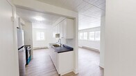 Located at 2620 Sycamore Drive in Windsor, Ontario, this well-appointed 2-bedroom, 1-bathroom unit offers a clean, modern interior spread across a single floor. The open layout connects the kitchen, dining, and living areas, creating a functional and cohesive living space filled with natural light from multiple windows.

The kitchen is thoughtfully designed with crisp white cabinetry extending to the ceiling for ample storage, a dark countertop with a stainless steel double sink, and a full suite of stainless steel appliances including a refrigerator, stove, and over-the-range microwave. Light hardwood-style flooring runs throughout, complementing the bright white walls and tile-panel ceilings.

The spacious living room benefits from large windows on two walls, allowing abundant natural light and views of the surrounding neighbourhood. Baseboard heaters are present throughout the unit, providing consistent warmth.

The primary bedroom is a comfortable size, featuring a window with an outdoor view and two full-width bifold closets, offering generous storage. The second bedroom is cozy and bright with its own window. The bathroom is finished with large-format white wall tiles surrounding a tub-shower combo, grey floor tiles, and a clean, minimal aesthetic throughout.