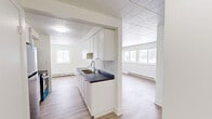Located at 2620 Sycamore Drive in Windsor, Ontario, this well-appointed 2-bedroom, 1-bathroom unit offers a clean, modern interior spread across a single floor. The open layout connects the kitchen, dining, and living areas, creating a functional and cohesive living space filled with natural light from multiple windows.

The kitchen is thoughtfully designed with crisp white cabinetry extending to the ceiling for ample storage, a dark countertop with a stainless steel double sink, and a full suite of stainless steel appliances including a refrigerator, stove, and over-the-range microwave. Light hardwood-style flooring runs throughout, complementing the bright white walls and tile-panel ceilings.

The spacious living room benefits from large windows on two walls, allowing abundant natural light and views of the surrounding neighbourhood. Baseboard heaters are present throughout the unit, providing consistent warmth.

The primary bedroom is a comfortable size, featuring a window with an outdoor view and two full-width bifold closets, offering generous storage. The second bedroom is cozy and bright with its own window. The bathroom is finished with large-format white wall tiles surrounding a tub-shower combo, grey floor tiles, and a clean, minimal aesthetic throughout.