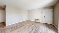 Located at 2635 Contra Costa Blvd in Pleasant Hill, CA, this one-bedroom, one-bathroom unit offers a well-organized, single-floor layout designed for comfortable everyday living. Light-toned hardwood flooring flows consistently throughout the space, complemented by neutral warm-beige walls and textured ceilings that give each room a clean, cohesive feel.

The open living and dining area is bright and welcoming, with a ceiling fan overhead and a sliding glass door that fills the room with natural light and leads out to a private balcony. The galley-style kitchen is thoughtfully appointed with rich wood cabinetry, dark granite countertops, stainless steel appliances, and a window that brings in additional daylight.

The spacious bedroom offers a comfortable retreat with ample room and direct access to the full bathroom, which features a wood vanity with granite countertop, a full tub/shower combination, and clean, modern fixtures. Two closets serve the unit, including a generous walk-in closet outfitted with built-in shelving and hanging rods, and a stacked washer and dryer conveniently tucked inside. A hallway connects the main living areas, ensuring a functional and efficient flow throughout the home.