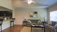 Located at 8254 County Road 64 in Daphne, Alabama, this single-story home offers a comfortable and well-designed layout suited for everyday living. The living room serves as the heart of the home, showcasing vaulted ceilings that lend a sense of openness and volume to the space. Rich hardwood flooring runs throughout, adding warmth and a classic aesthetic that complements the neutral, soft-toned walls. A ceiling fan centered overhead provides both function and a finishing touch to the room's design. The living area is generously proportioned, easily accommodating a full seating arrangement with ample room to move. Subtle architectural details, including clean lines and a simple yet refined trim work, contribute to the overall cohesive feel of the interior. The neutral color palette throughout creates a bright, airy atmosphere that allows the space to feel open and inviting. The home's single-floor layout offers convenient, accessible living, with spaces that flow naturally from one to the next. Situated in the desirable Daphne, Alabama area, this property combines practical design with a relaxed, residential charm that is characteristic of the region.