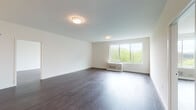 Located at 22 Sussex St in Hackensack, NJ, this contemporary single-floor residence offers a thoughtfully designed layout with clean lines and modern finishes throughout. Rich, dark hardwood flooring runs seamlessly across the living areas, creating a warm contrast against the crisp white walls and ceilings. The generously proportioned living area is bathed in natural light through large picture windows that frame views of lush greenery, lending the space an airy, inviting atmosphere.

The kitchen is a standout feature, outfitted with stainless steel appliances including a gas range, over-the-range microwave, and a French door refrigerator. Two-tone cabinetry pairs warm wood-finish lower cabinets with white upper cabinets, while sleek stone countertops with marble-like veining extend to an integrated peninsula — ideal for casual dining or meal prep. The entry foyer flows naturally into this culinary space.

The residence includes two well-appointed bathrooms. The primary bath features a large-format walk-in shower enclosed by sliding glass doors, a marble-top floating vanity, and wood-toned tile accents. The secondary bathroom offers a soaking tub with subway tile surround, a backlit vanity mirror, and a distinctive pebble-mosaic tile floor. Additional bedrooms are bright and spacious, each benefiting from large windows with outdoor views.