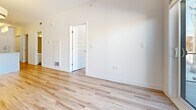 Located at 40 Kirkland Private in Ottawa, Ontario, this well-designed 2-bedroom, 1-bathroom unit offers a clean, contemporary aesthetic across a single floor. Light oak laminate flooring runs throughout the living spaces and bedrooms, contributing to a bright and cohesive feel. The open-concept kitchen and living area serves as the heart of the unit, featuring white flat-panel cabinetry, warm wood open shelving, subway tile backsplash, light quartz countertops, and stainless steel appliances including a bottom-freezer refrigerator and electric range. A kitchen island provides additional prep and dining space. The living area offers access to a balcony through a sliding glass door, bringing in natural light. The primary bedroom is a well-proportioned room with a window overlooking the surrounding neighbourhood, while the second bedroom is a comfortable space with its own dedicated closet. Both bedrooms are finished with the same light laminate flooring and crisp white walls. The bathroom features a modern floating white vanity with a vessel sink, dark countertop, large mirror, and wood-look tile flooring, adding a stylish contrast to the otherwise bright palette. A dedicated closet provides additional storage. The unit presents a clean, move-in-ready interior with consistent modern finishes throughout.