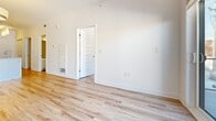 Located at 40 Kirkland Private in Ottawa, Ontario, this well-designed 2-bedroom, 1-bathroom unit offers a clean, contemporary aesthetic across a single floor. Light oak laminate flooring runs throughout the living spaces and bedrooms, contributing to a bright and cohesive feel. The open-concept kitchen and living area serves as the heart of the unit, featuring white flat-panel cabinetry, warm wood open shelving, subway tile backsplash, light quartz countertops, and stainless steel appliances including a bottom-freezer refrigerator and electric range. A kitchen island provides additional prep and dining space. The living area offers access to a balcony through a sliding glass door, bringing in natural light. The primary bedroom is a well-proportioned room with a window overlooking the surrounding neighbourhood, while the second bedroom is a comfortable space with its own dedicated closet. Both bedrooms are finished with the same light laminate flooring and crisp white walls. The bathroom features a modern floating white vanity with a vessel sink, dark countertop, large mirror, and wood-look tile flooring, adding a stylish contrast to the otherwise bright palette. A dedicated closet provides additional storage. The unit presents a clean, move-in-ready interior with consistent modern finishes throughout.