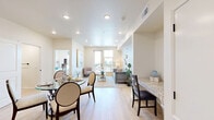 Located at 4064 E Live Oak Ave in Arcadia, CA, this thoughtfully designed 2-bedroom, 1-bathroom residence offers a bright and modern living experience on a single floor. Light wood flooring flows seamlessly throughout, tying each space together with a clean, contemporary aesthetic.

The open-concept layout connects the kitchen, dining, and living areas into one cohesive entertaining space. The kitchen is a standout feature, showcasing bold navy blue lower cabinets paired with crisp white upper cabinets, quartz countertops, a classic subway tile backsplash, stainless steel appliances, and a movable island — combining both style and functionality. The adjacent dining area accommodates a full dining set, while the living room is bathed in natural light from large windows and a glass door that opens to a private balcony with outdoor views.

The primary bedroom is a comfortable retreat with recessed lighting, warm neutral tones, and direct sightlines to the vibrant kitchen. The second bedroom features a built-in closet and ample space. The bathroom is well-appointed with a glass-enclosed walk-in shower, a sleek vanity with navy cabinetry, and modern matte black fixtures. A dedicated laundry area adds everyday convenience to this well-rounded home.