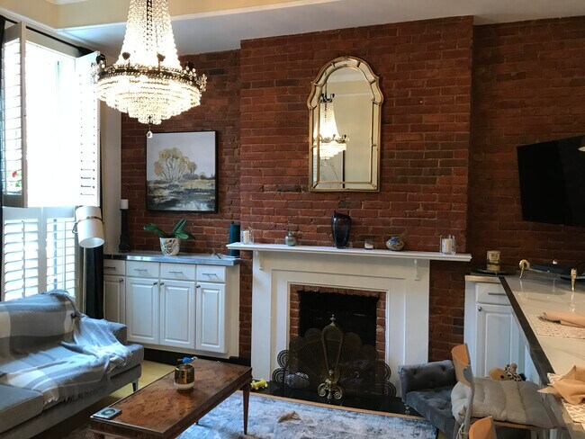 Living room with exposed brick and fireplace - 1118 10th St NW