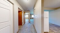 Located at 206 E 15th Ave in Ellensburg, WA, this one-bedroom, one-bathroom unit offers a practical and efficiently organized single-floor layout. A carpeted hallway connects the main living areas, providing a clean transition between spaces.

The kitchen is well-appointed with warm wood cabinetry extending to the upper walls for generous storage, dark laminate countertops, tile flooring, and white appliances including an electric range, dishwasher, and full-size refrigerator. A range hood and under-cabinet lighting add functional detail to the space.

The bedroom is carpeted and features a large sliding wood-panel closet, a window that allows natural light to fill the room, and a baseboard heater. The neutral wall tones and simple finishes keep the space feeling clean and open.

The bathroom includes a full tub and shower combo with a curved curtain rod, tile flooring that complements the kitchen, a wood vanity with dark countertop, and straightforward, functional fixtures throughout.

The textured ceilings and neutral color palette are consistent throughout the unit, contributing to a cohesive and understated aesthetic. This space is well-suited for a single occupant seeking a straightforward, move-in-ready home in Ellensburg.