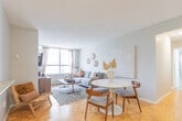Located at 300 Regina St N in Waterloo, Ontario, this 3-bedroom, 1-bathroom unit offers a well-organized single-floor layout designed to maximize functionality. The living room serves as the heart of the space, featuring warm parquet hardwood flooring and a large picture window that floods the room with natural light while framing views of the surrounding urban cityscape. The neutral grey tones and textured ceiling lend a clean, modern aesthetic throughout.

The galley-style kitchen is efficiently laid out with floor-to-ceiling white cabinetry, grey countertops, stainless steel appliances including a refrigerator, electric range, and dishwasher, all set above light tile flooring for easy maintenance.

All three bedrooms benefit from natural light through individual windows with urban views. The spacious primary bedroom offers ample room for a full bedroom suite, while the two additional bedrooms each provide comfortable, versatile spaces with built-in or closet storage options. Parquet hardwood flooring runs throughout the bedrooms, adding warmth and continuity.

The bathroom is clean and functional, featuring a shower-tub combo, vanity with mirror, and neutral finishes. Two hallways connect the rooms efficiently, completing the practical and cohesive layout of this multi-bedroom Waterloo residence.