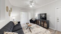 Located at 520 Windview Way in Knoxville, TN, this thoughtfully designed one-bedroom, one-bathroom residence offers a comfortable and functional single-floor layout. The open-concept living, dining, and kitchen area forms the heart of the home, bathed in natural light from large windows fitted with blinds. The living room features crown molding, a ceiling fan, and sliding glass doors that lead to a private patio. The adjacent dining area is highlighted by a pendant light fixture and a bright window with outdoor views, creating an inviting space for meals. The kitchen is well-appointed with white cabinetry, ample counter space, and full appliances including a range and refrigerator, with easy access to the dedicated laundry area. The spacious primary bedroom is carpeted for comfort, includes a ceiling fan, multiple windows, and benefits from two closets — one of which is a walk-in. The full bathroom features a tub/shower combination, a vanity with a large mirror, and hardwood-style flooring. Additional storage is provided throughout, including a second closet and extra cabinetry. The neutral, light-toned palette and wood-style flooring across the main living areas contribute to a clean, modern ambiance throughout.