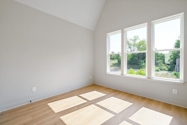 Building Photo - Captivating end unit townhome with covered...