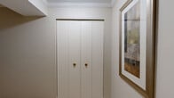 Located in Owings Mills, MD, this thoughtfully designed 2-bedroom, 2-bathroom single-floor residence offers a comfortable and cohesive living experience. Crown molding is featured throughout, adding a refined architectural detail to every room.

The layout includes two distinct living areas, both featuring plush carpeting, neutral tones, and generous natural light. The main living room is spacious and open, with room for a large sectional sofa and a glass coffee table, while a second living area provides additional flexibility for relaxing or entertaining.

The kitchen is efficiently designed with white raised-panel cabinetry, ample counter space, and full appliances including a gas range and refrigerator, all finished in white for a clean, classic look.

The generously sized primary bedroom features large windows with outdoor views, soft carpeting, crown molding, and direct access to a walk-in closet with built-in shelving and hanging rods. The second bedroom is equally well-proportioned. Both bathrooms are finished with white tile flooring and include a walk-in shower.

A dedicated laundry room houses a full-size washer and dryer with overhead shelving. Four closets throughout the home provide exceptional storage. The welcoming entrance completes this well-organized and functional residence.